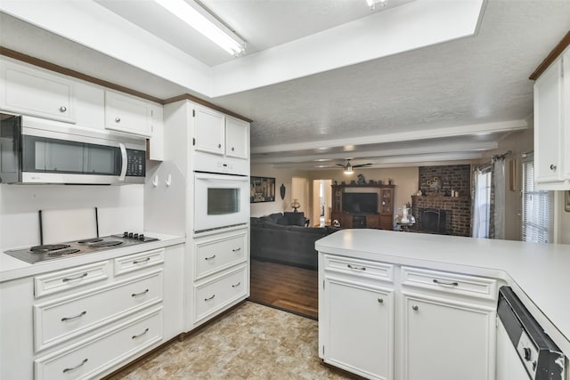 kitchen featuring white appliances, light hardwood / wood-style floors, white cabinetry, and ceiling fan