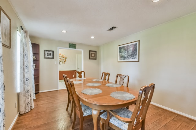 dining space with light hardwood / wood-style floors