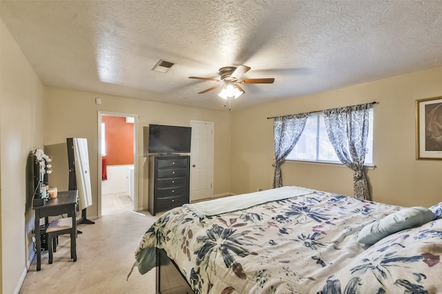 carpeted bedroom featuring ceiling fan and a textured ceiling