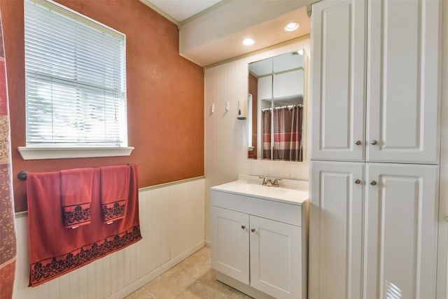 bathroom with tile patterned floors, vanity, and crown molding