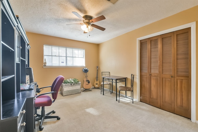 office with ceiling fan, carpet floors, and a textured ceiling