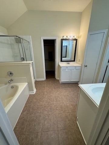 bathroom featuring separate shower and tub, tile patterned floors, vanity, and lofted ceiling