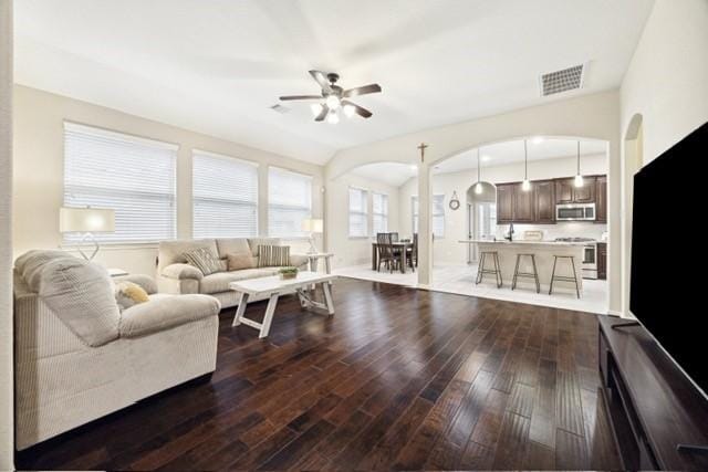 living room featuring ceiling fan and dark wood-type flooring