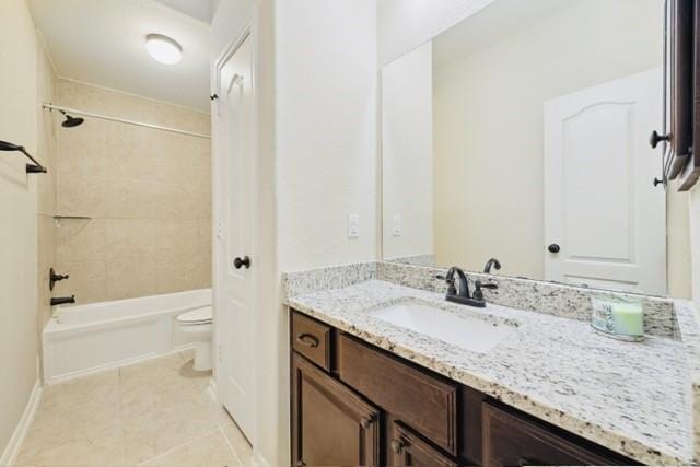 full bathroom with tile patterned flooring, vanity, toilet, and tiled shower / bath