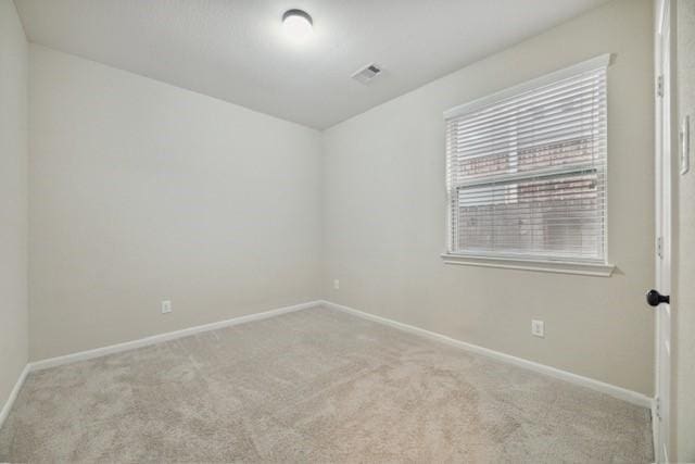 unfurnished room with light carpet