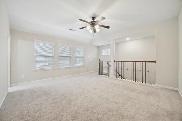 unfurnished room featuring ceiling fan and light colored carpet