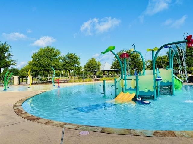 view of swimming pool with pool water feature