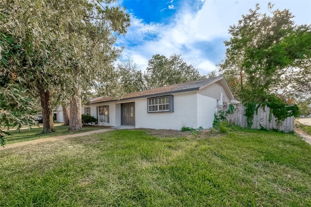 ranch-style home featuring a front yard