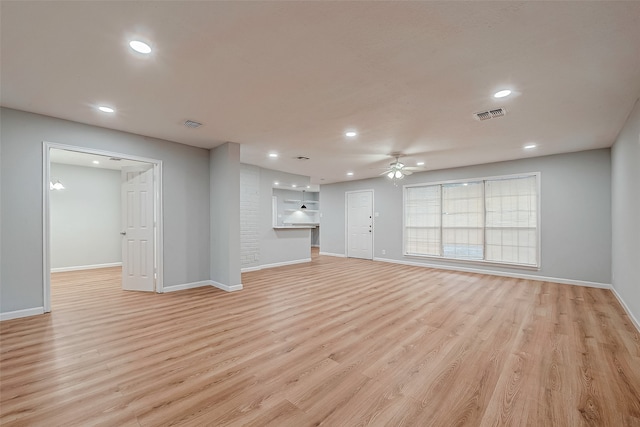 unfurnished living room featuring ceiling fan and light hardwood / wood-style floors