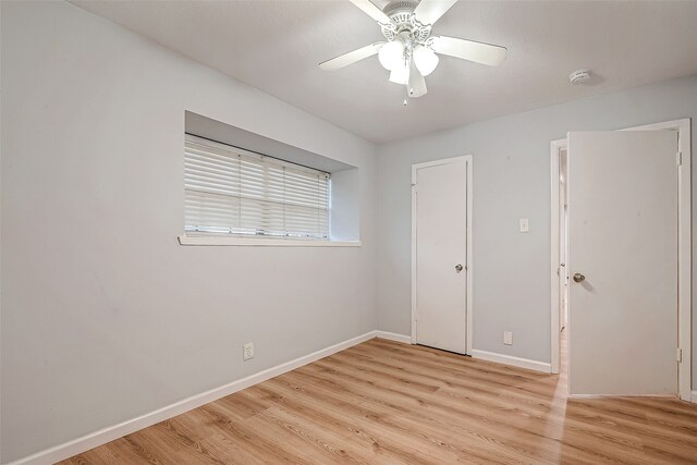 empty room featuring ceiling fan and light wood-type flooring