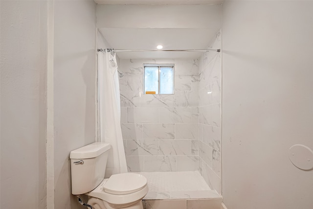 bathroom with a shower with curtain and toilet