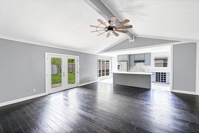 unfurnished living room with dark wood-type flooring, a textured ceiling, lofted ceiling with beams, french doors, and ceiling fan