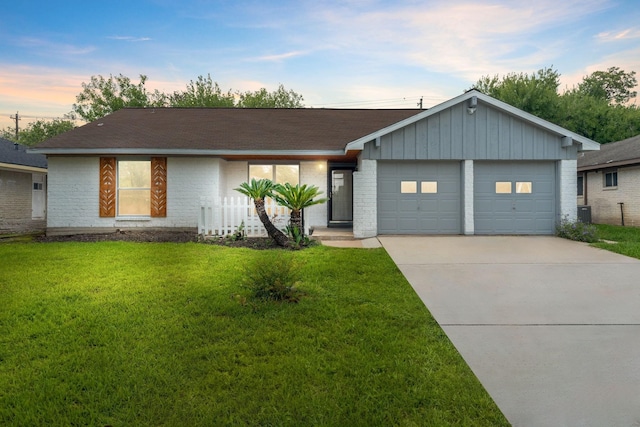 single story home with a lawn and a garage