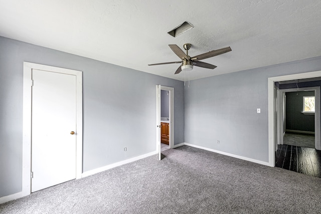 unfurnished bedroom featuring dark colored carpet and ceiling fan