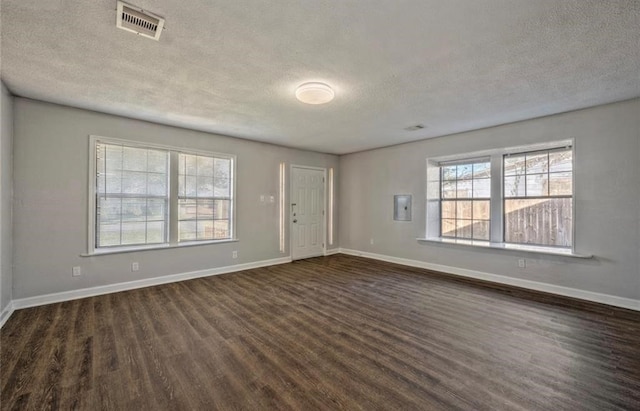 interior space with a textured ceiling and dark wood-type flooring