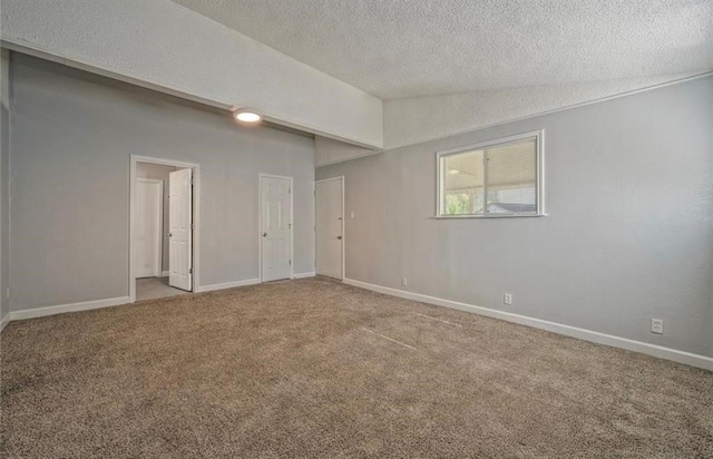 spare room with carpet flooring and a textured ceiling