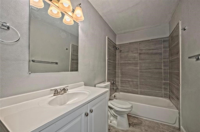 full bathroom with tiled shower / bath combo, tile patterned floors, a textured ceiling, toilet, and vanity