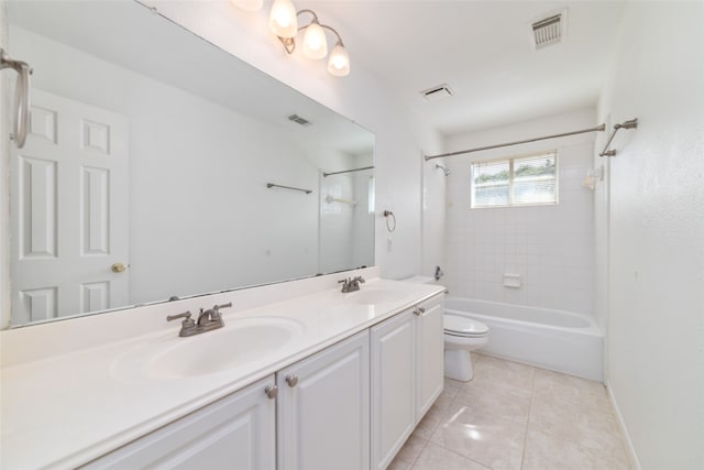 full bathroom featuring tile patterned flooring, vanity, toilet, and tiled shower / bath