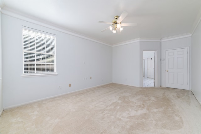 carpeted empty room featuring ceiling fan and ornamental molding