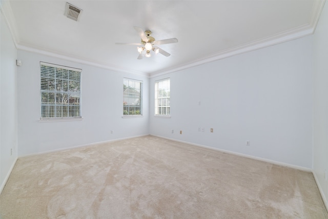 carpeted empty room with ceiling fan and ornamental molding