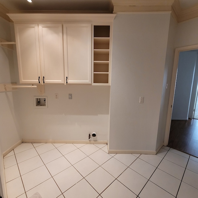 laundry area with light tile patterned flooring, cabinets, crown molding, and hookup for a washing machine