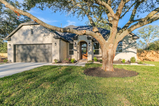 view of front of home with a front yard and a garage