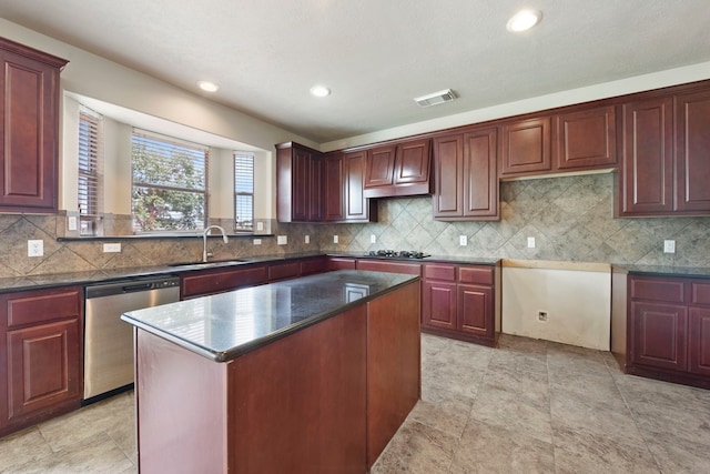 kitchen with sink, backsplash, dishwasher, and a kitchen island