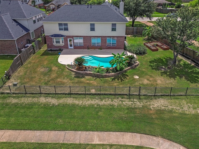 exterior space featuring a fenced in pool, a yard, and a patio area