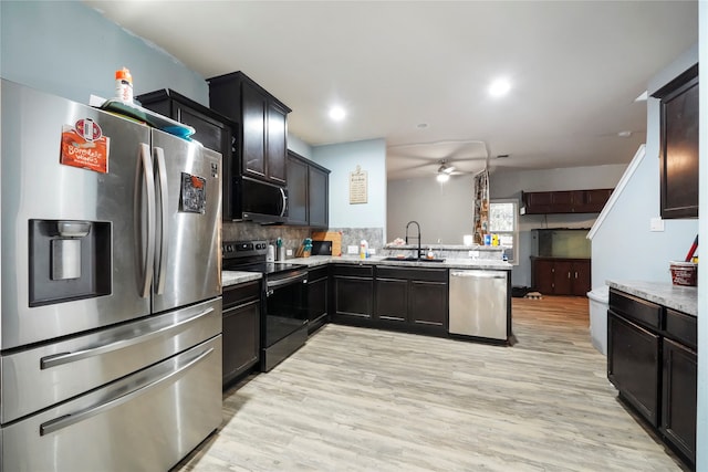 17039 Midships Way, Crosby, TX 77532 - kitchen with sink, kitchen peninsula, decorative backsplash, appliances with stainless steel finishes, and light wood-type flooring