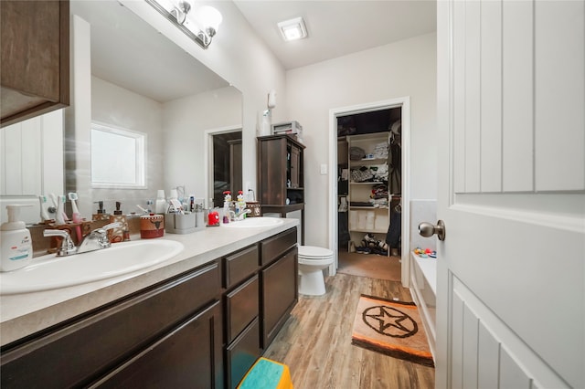 17039 Midships Way, Crosby, TX 77532 - bathroom with vanity, toilet, and wood-type flooring