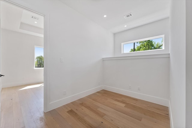 empty room featuring visible vents, baseboards, recessed lighting, and light wood-style floors