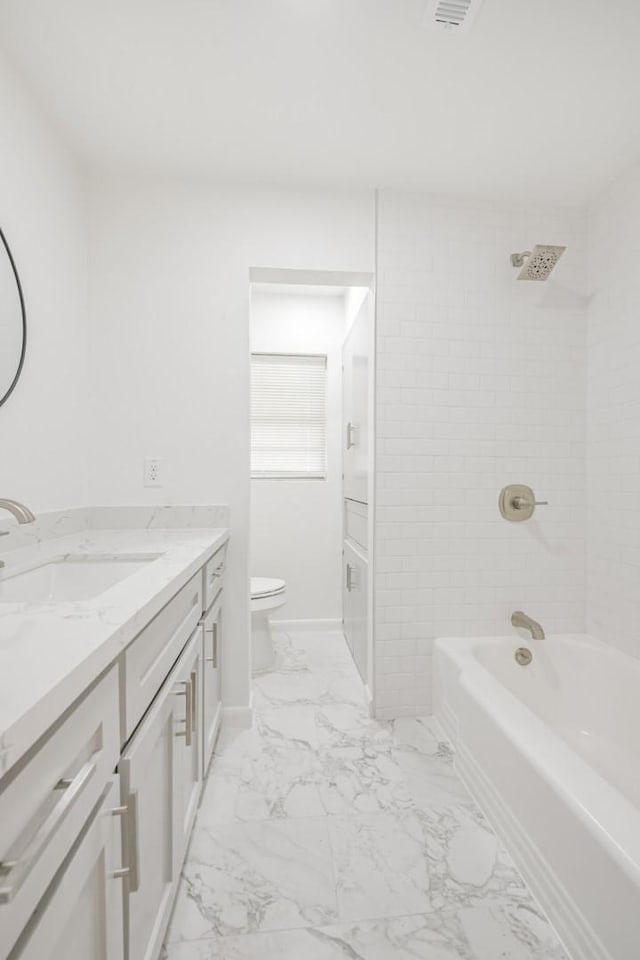 full bathroom featuring vanity, toilet, and tiled shower / bath