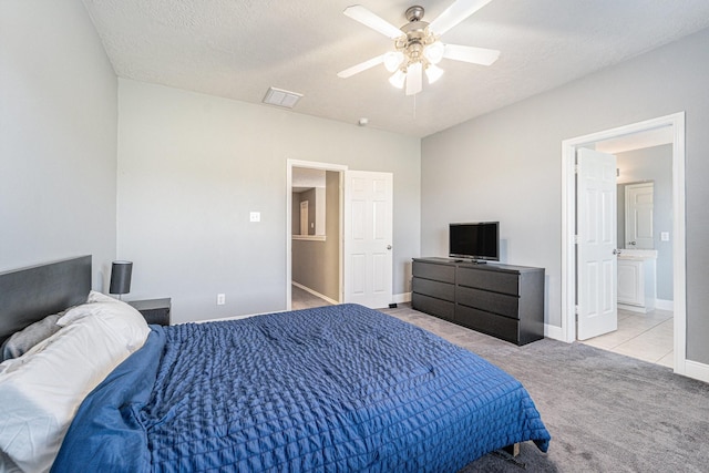 carpeted bedroom featuring a ceiling fan, baseboards, visible vents, a textured ceiling, and connected bathroom