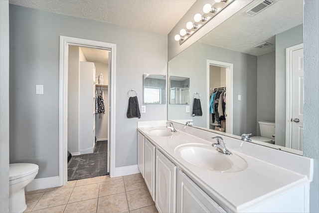 full bath featuring visible vents, toilet, and a sink