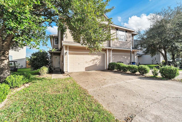 view of front of house with driveway, an attached garage, and a front yard