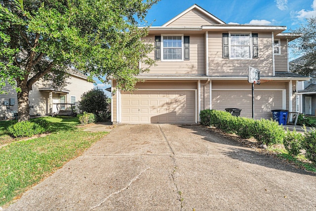 view of front of property featuring driveway, a front yard, and an attached garage