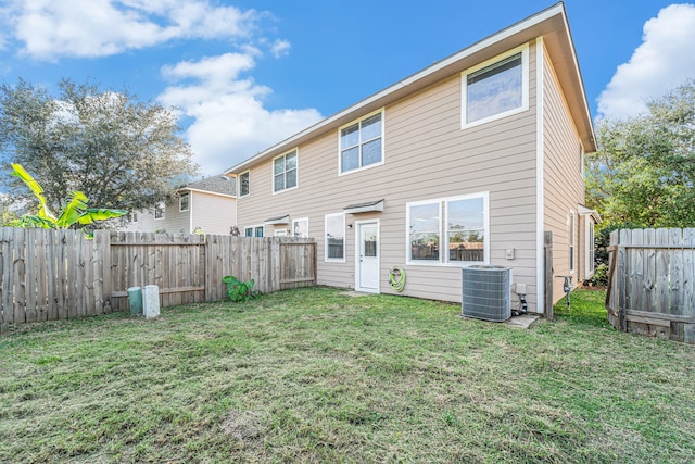 back of property with a yard and cooling unit