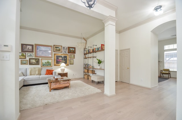 living room with ornate columns, light hardwood / wood-style floors, and ornamental molding