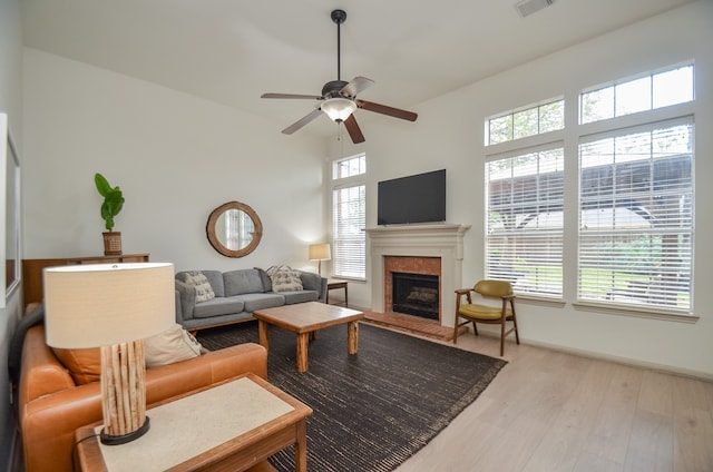 living room featuring ceiling fan and light hardwood / wood-style floors