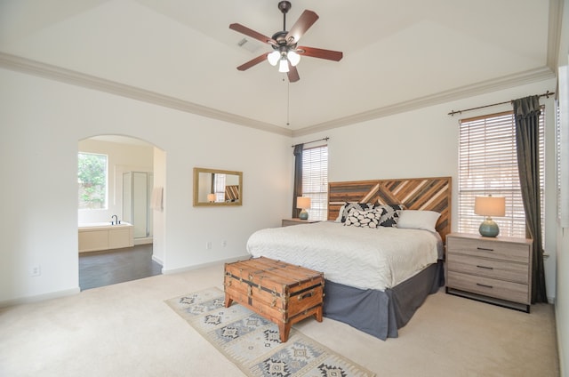 carpeted bedroom featuring ceiling fan, crown molding, and connected bathroom