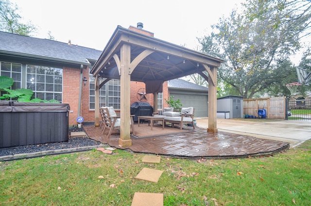 view of patio featuring outdoor lounge area, a gazebo, a shed, a grill, and a hot tub