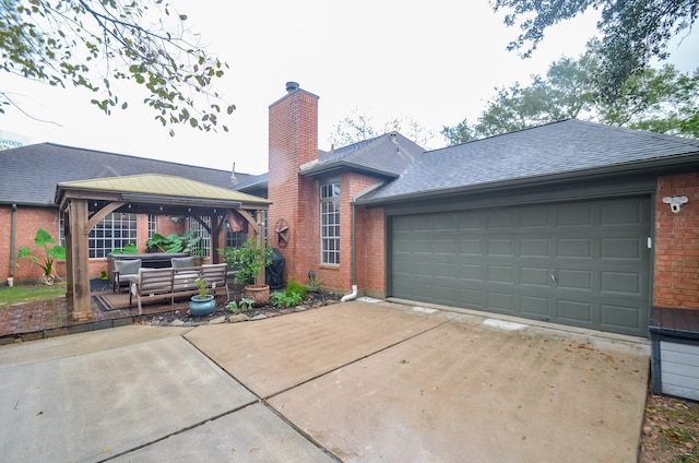 view of front facade with a gazebo and outdoor lounge area