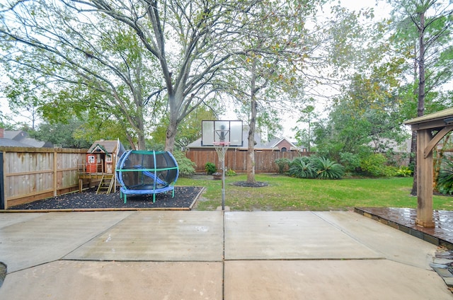 view of patio with a playground and a trampoline