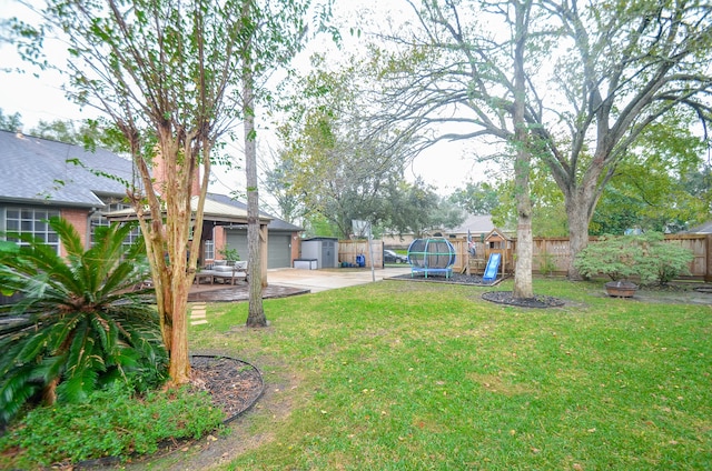 view of yard featuring a playground, a patio, and a trampoline