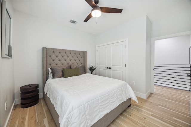 bedroom with ceiling fan, a closet, and light wood-type flooring