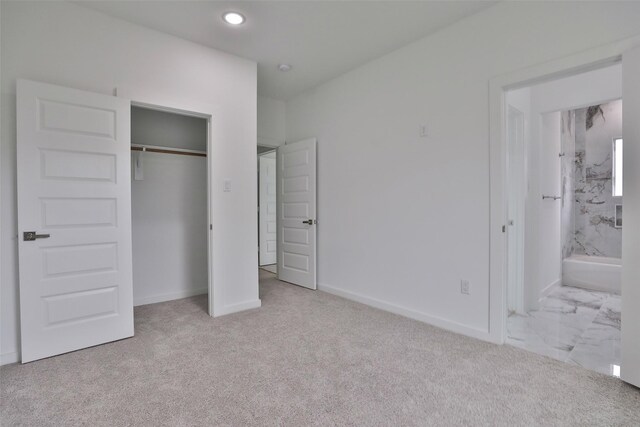 9339 Lavender St, North Houston, TX 77016 - unfurnished bedroom featuring a closet, ensuite bathroom, carpet, and recessed lighting