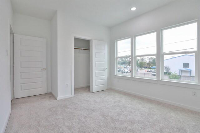 9339 Lavender St, North Houston, TX 77016 - unfurnished bedroom with light carpet, baseboards, a closet, and recessed lighting