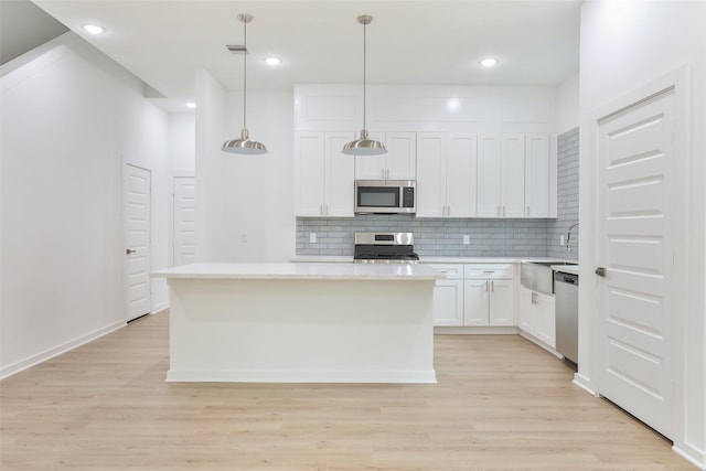 9339 Lavender St, North Houston, TX 77016 - kitchen featuring appliances with stainless steel finishes, light wood-style flooring, backsplash, light countertops, and recessed lighting