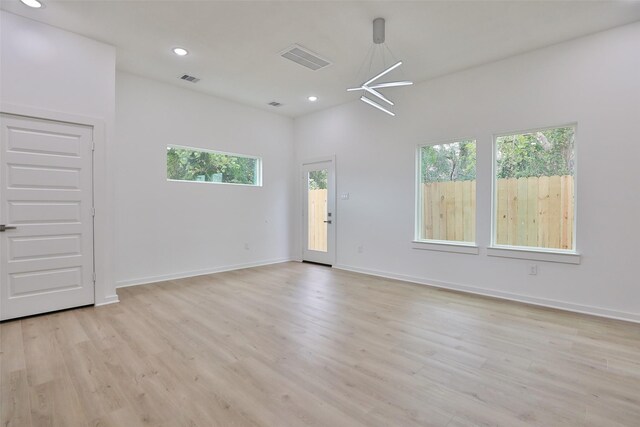 9339 Lavender St, North Houston, TX 77016 - unfurnished room featuring healthy amount of natural light, light wood-style floors, recessed lighting, and baseboards