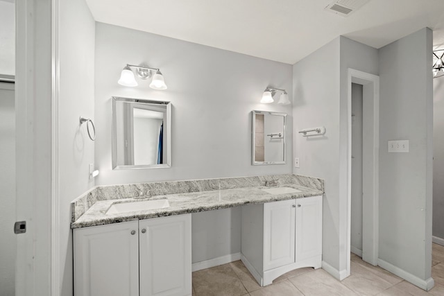 bathroom featuring tile patterned flooring and vanity